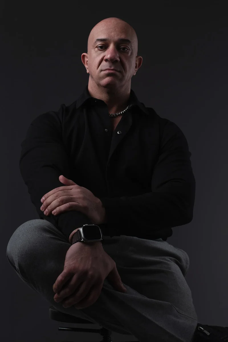 Akmal Kadri in a studio portrait with arms crossed